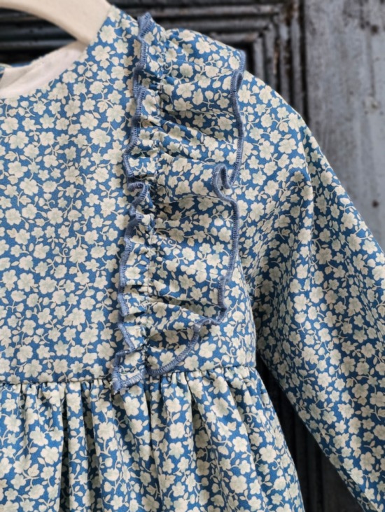 Vista frontal del vestido floral para niña, diseño elegante de Sutier, con detalles delicados y colores vibrantes.